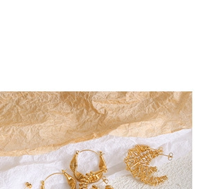 Detailed view of various vintage gold-plated titanium earrings with intricate patterns