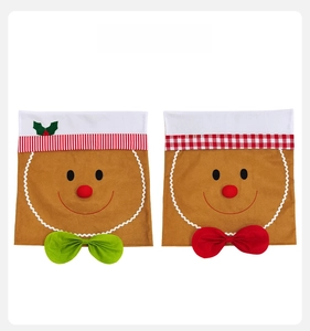 Detail of gingerbread man Christmas chair covers with white faux fur and festive bows