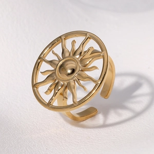 Gold plated stainless steel sun ring with hollow sunburst pattern and casting shadow