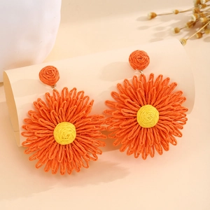 Vibrant orange handmade woven raffia flower drop earrings for a summer vacation look