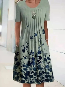 Sage green short-sleeve midi dress with blue floral print and pleated neckline