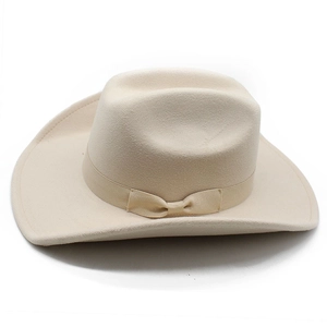 Detailed macro view of the light beige wool felt cowboy hat with a silk bow decoration
