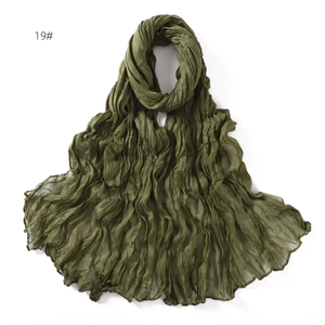 Detail showing army green crinkle textured lightweight cotton linen scarf in a soft drape