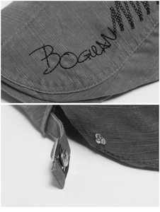 Detail of grey cotton beret showing black BOGUAN embroidery and adjustable metal buckle