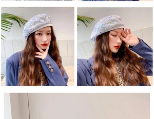 Detailed view of a white sequined beret hat worn with a stylish blue blazer