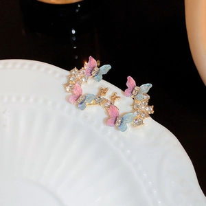 Vintage gold butterfly earrings with pink-blue gradient wings and pearl accents
