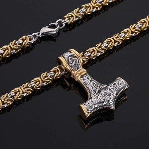 Macro detail of bicolored Thor's Hammer Mjölnir pendant with intricate Byzantine chain