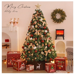 Close-up of decorated Christmas tree with red gold baubles, reindeer tree skirt and gift boxes