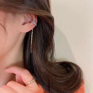 Detail of silver C-shaped ear cuff with sparkling zircon fringe on model's ear