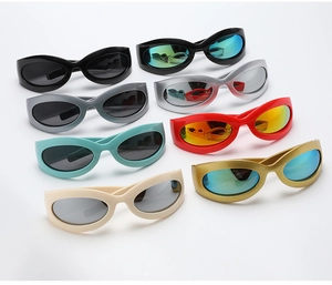Flat lay of Y2K oval sunglasses in multiple colors like silver, red, and blue frames