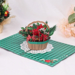 3D Pop-up Christmas card featuring a flower basket with red poinsettias and pine cones