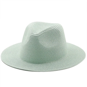 Detailed texture of mint green woven straw fedora hat for summer sun protection