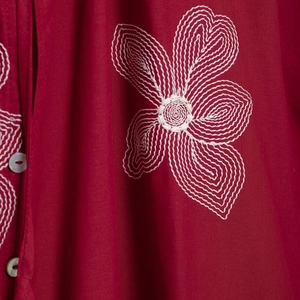 Retro raspberry red blouse featuring white floral embroidery and classic buttons