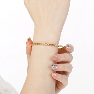 Detailed view of 18K gold plated bangle featuring oval borders and sparkling white zircons