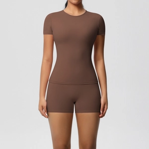 Detailed view of the brown athletic yoga set showing slim fit short sleeve and shorts
