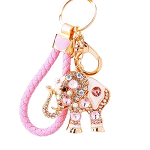 Pink braided keychain with gold-tone metal and sparkling crystal-studded elephant pendant