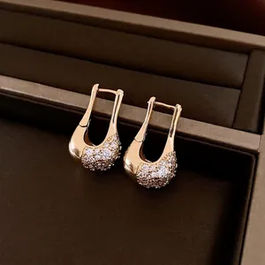 U-shaped rose gold earrings with pavé cubic zirconia displayed in a velvet jewelry box
