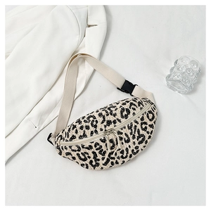 Detail of leopard print woven waist bag featuring adjustable strap and texture