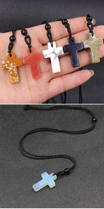 Detailed close-up of woven cross necklaces in natural agate, opal, and diverse gemstones