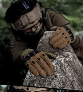 Tactical climbing gloves with hard knuckle protection shown on a model scaling a rock