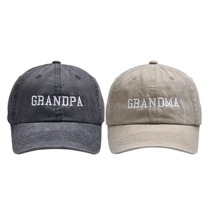 Macro shot of embroidered Grandpa and Grandma letters on washed cotton baseball caps
