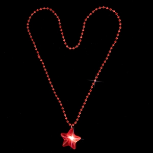 Macro shot of red beaded necklace shaped in a heart with a glowing star pendant