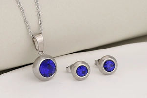 Detailed set of silver stainless steel necklace and stud earrings with blue gemstones