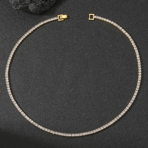 Close-up of golden tennis necklace featuring square-cut zircons and secure box clasp