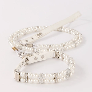Close-up of double-row pearl pet collar with rhinestone accents and silver hardware