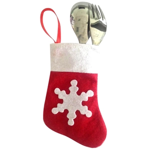 Christmas felt sock cutlery holder with white snowflake pattern and stainless steel utensils