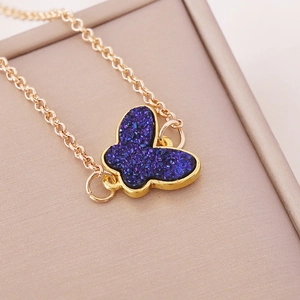 Chic golden O-chain necklace featuring a blue crystal butterfly pendant in vintage style