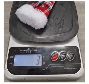 Mini red and white plaid Christmas hat cutlery holder weighing only 3g on a digital scale