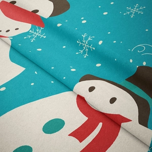 Macro shot of soft blue flannel fabric with snowman and snowflake prints for Christmas décor