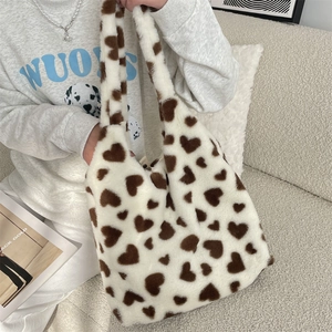 Lifestyle shot of large plush heart tote bag with soft faux fur texture for winter