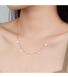 Detail of S925 sterling silver necklace with five round disk pendants on a fine chain