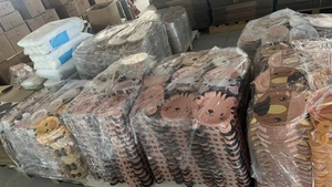 Bulk stack of animal shaped paper plates for kids party in a storage warehouse