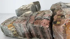 Bulk stack of animal shaped paper plates for kids party in a storage warehouse