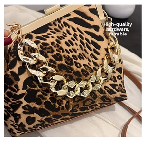Close-up of leopard print shell bag featuring a chunky gold chain and rhinestone details