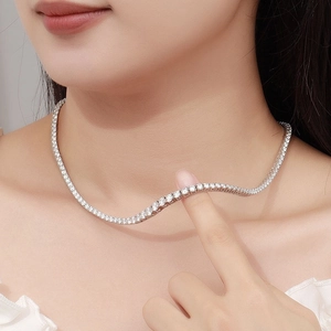 Detailed close-up of a silver-tone tennis necklace with gradient cubic zirconia stones