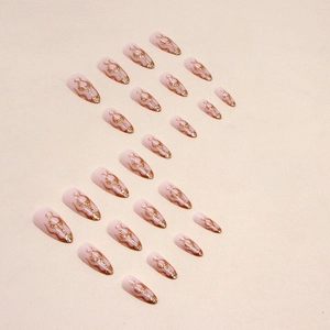 Sparkling gold glitter flame almond press-on nails in elegant nude pink finish