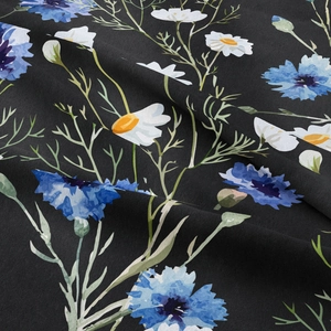 Close-up of bohemian floral tapestry fabric with blue cornflowers and white daisies