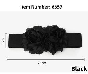 Detailed view of a 6cm wide black elastic belt with two large decorative fabric flowers