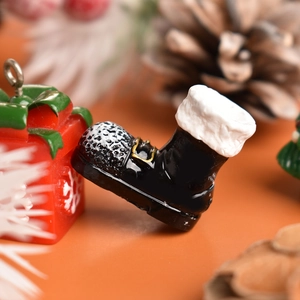 Macro detail of a resin black Christmas boot ornament with gold buckle and fuzzy white trim