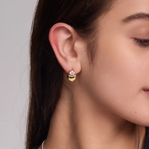 Elegant gold heart stud earrings with sparkling round zircon stone worn on earlobe