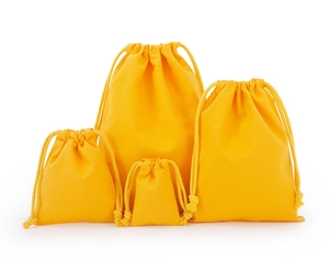 Detailed set of four yellow cotton drawstring bags in various sizes on white background