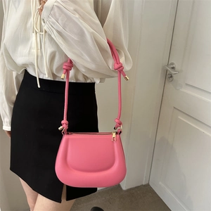Pink matte leather saddle shoulder bag with knotted strap and gold hardware details