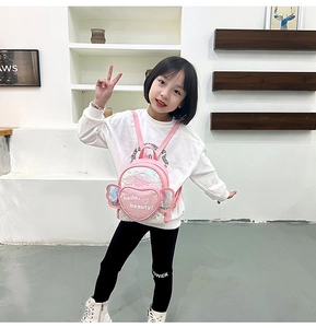 Detailed view of pink sequin kids backpack with heart pocket and cute wing elements