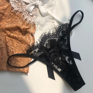 Detail of sheer eyelash lace thongs with silk satin bows in black, white and caramel