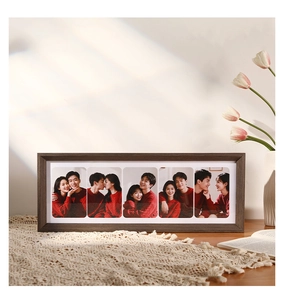 Detail of a 5-window solid wood photo frame in walnut finish on a lace tablecloth