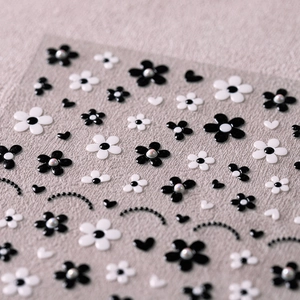 3D black and white floral nail stickers with pearl accents and 5-petal flower designs